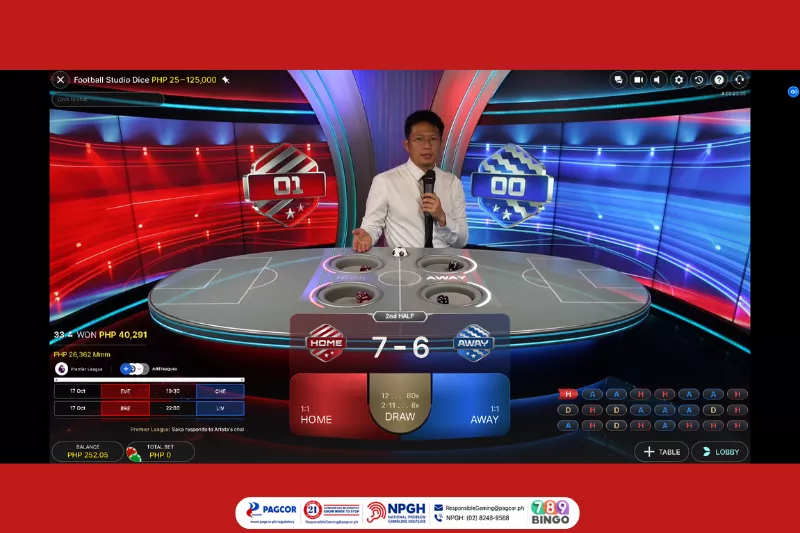 football studio dice, football studio dice game interface, dice, football, soccer ball, casino dice game, evolution, evolution live, male host, football-themed, dice table game, blue and red background, dim lights, pagcor, www.pagcor.ph/regulatory, npgh, national problem gambling helpline, npgh: (02) 8248-9568, ResponsibleGaming@pagcor.ph, 789bingo