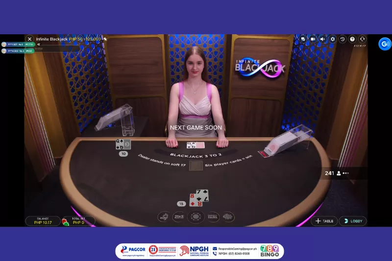 infinite blackjack, blackjack, casino card game, evolution, evolution live, female live dealer, blackjack table, blackjack cards, blackjack deck, card deck, blue and pink lights, wooden background, pagcor, www.pagcor.ph/regulatory, npgh, national problem gambling helpline, npgh: (02) 8248-9568, ResponsibleGaming@pagcor.ph, 789bingo